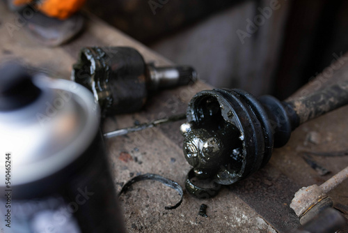 Obraz na płótnie Repair and replacement of the axle shaft and CV joint with an anther of an automobile drive. w salonie