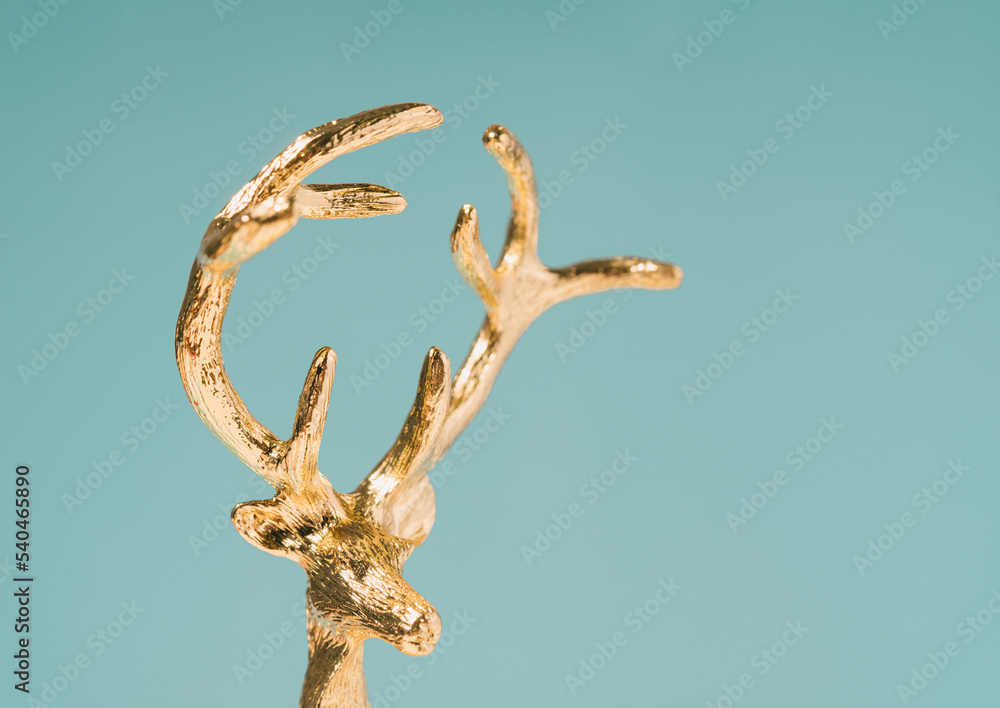 Fototapeta premium Christmas deer golden ornament macro. Winter holidays minimal background.
