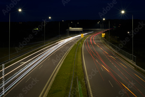 ON THE ROAD AT NIGHT - Car traffic on a modern expressway 