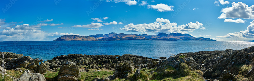 View east from the B8001 by Skipness, from north to south, a panoramic view of the Isle of Arran across the Kilbrannan Sound. Tarbert, Argyll and Bute. Scotland