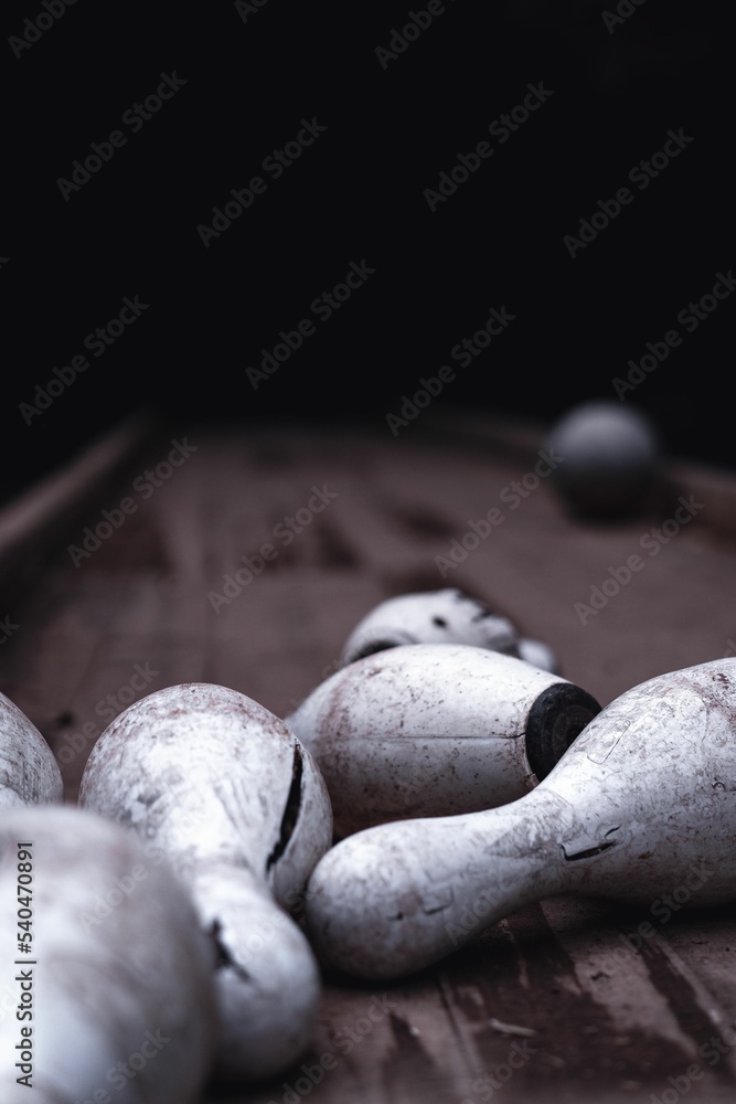 Vertical closeup of dirty broken bowling pins outdoors at Pavliani park