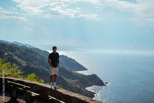 Young man in front of the aerial landscape view of San Sebastian, spain