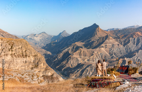 Couple of young hikers admiring the autumn mountains near the village of Golotl in the Khunzakh region of the Republic of Dagestan. photo