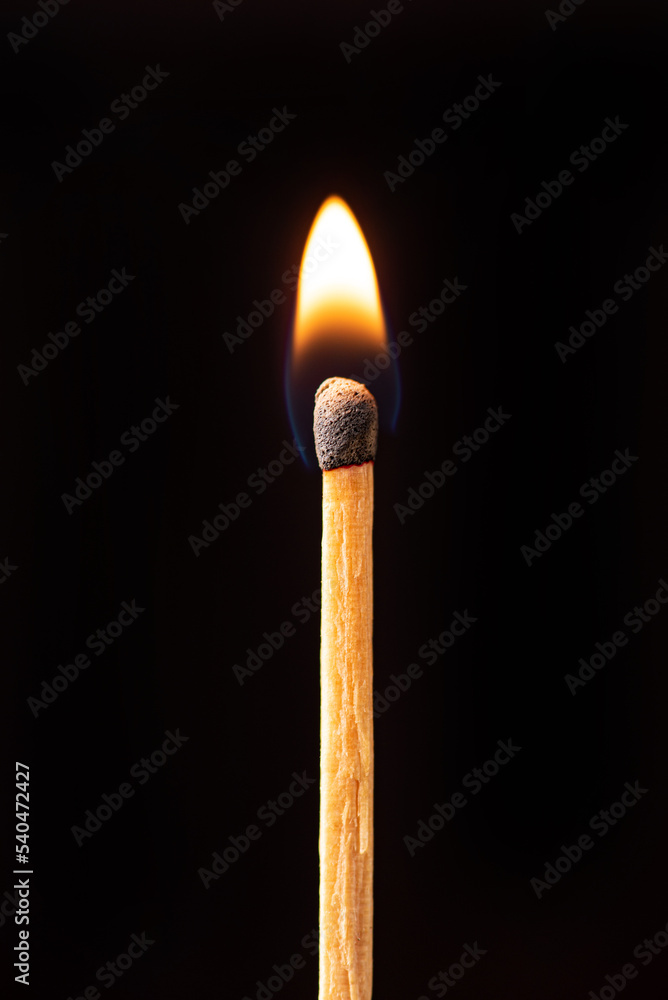 Matchstick burning in detail seen through a macro lens, black background, selective focus. Matchstick burning in detail seen through a macro lens, black background, selective focus.