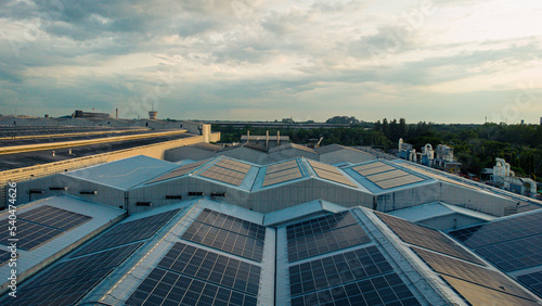 Footage over Solar cell on the roof of a large industrial factory. Solar roofs are generating renewable energy for the industry. The goal is to reduce the cost of electricity.