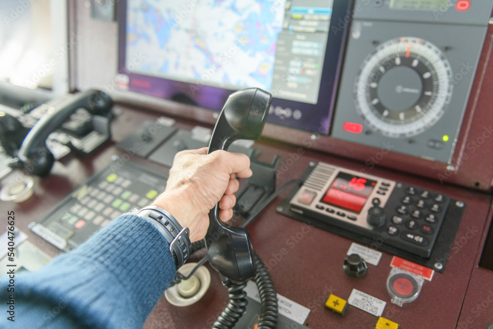 Navigational control panel and VHF radio with hand. Radio communication ...