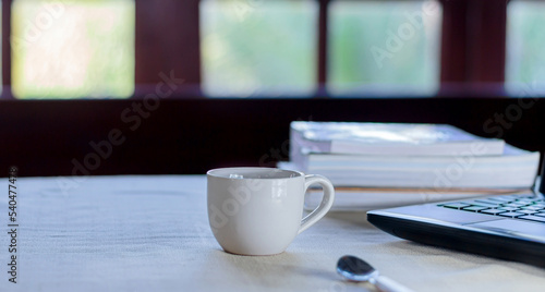 white coffee cup on the table