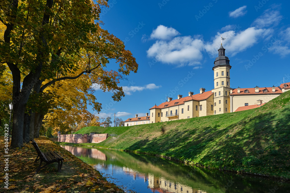 View of belorussian tourist attraction - Nesvizh castle in autumn landscape. Nesvizh, Minsk region, Belarus.