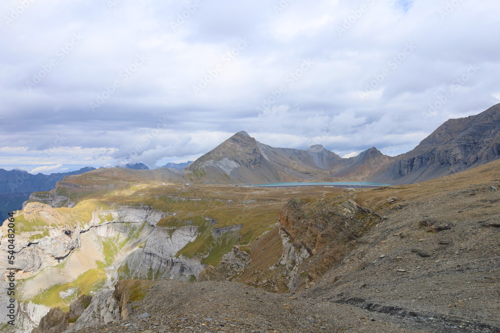 Fototapeta premium Limmerensee reservoir surrounded by Muttenchopf mountain and Muttsee mountain lake in Glarus, Switzerland