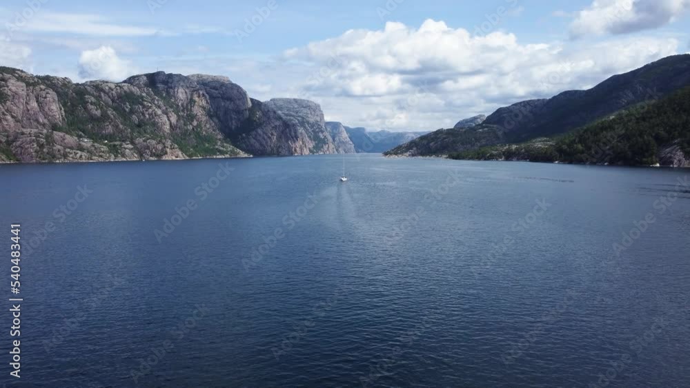 Sailboat Traversing Norwegian Fjord. Aerial View Sailboat Traversing Norwegian Fjord. Aerial View