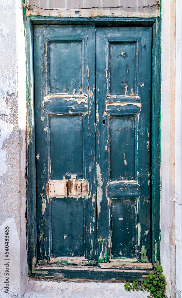 Weathered door at Paros in Greece with paint peeling