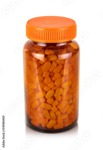 Vitamin or supplement tablets in brown glass bottle packaging with orange cap for supplement product design mock-up