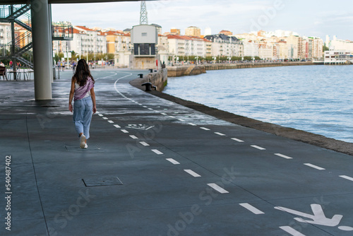 Girl walking along the Seafront in Santander