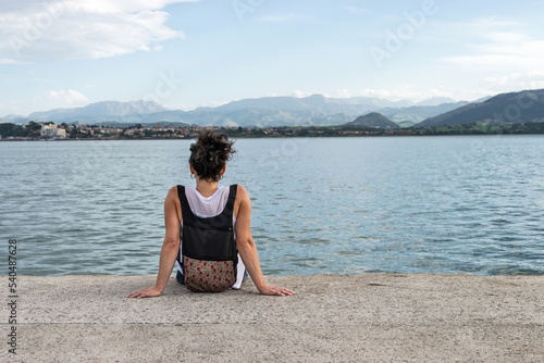 Woman sits on Santander Promenade