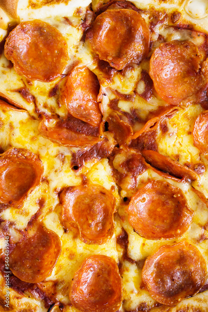 Close up of pepperoni pizza and texture of ingredient, vertical frame Close up of pepperoni pizza and texture of ingredient, vertical frame