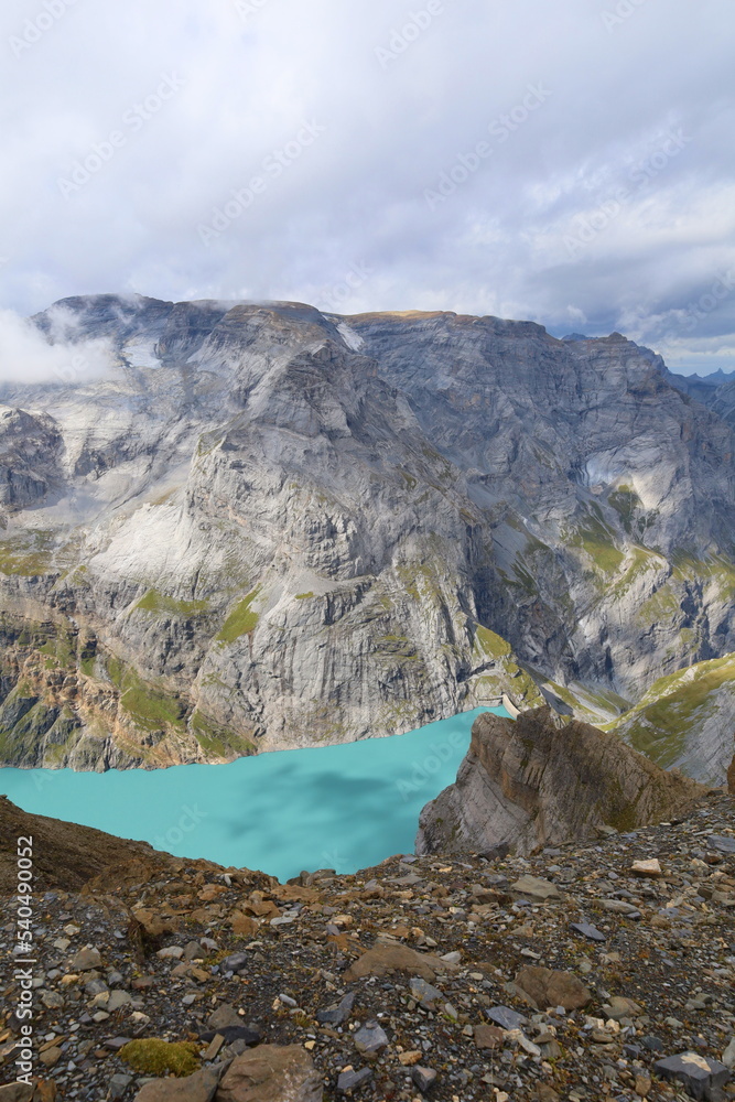 Obraz premium Limmerensee reservoir surrounded by Muttenchopf mountain and Muttsee mountain lake in Glarus, Switzerland