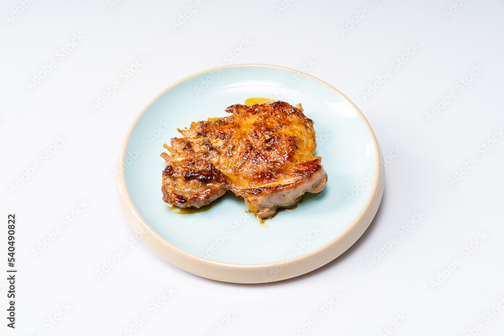 Fresh pan-fried chicken chops on a monochrome background