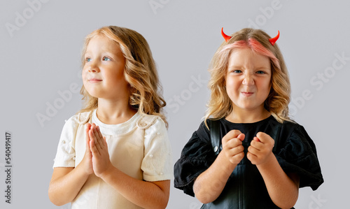 фотографія Little girl with bad and good behaviour