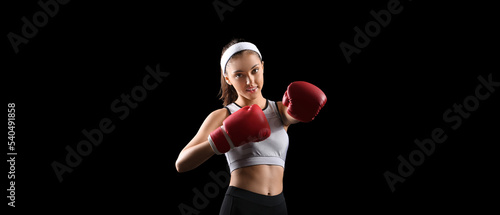Sporty young woman in boxin...