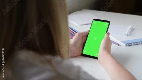 A teenager scrolls the tape in a smartphone