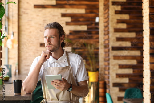 Thoughtful business owner w...