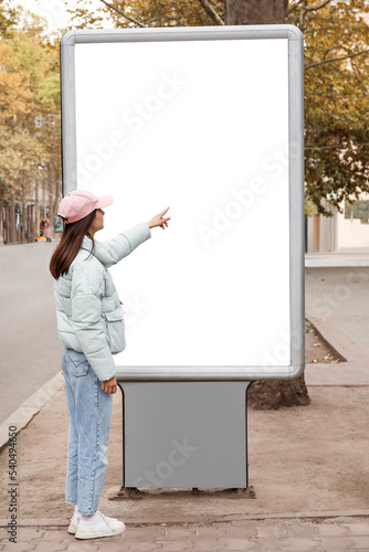 Woman near blank advertisin...