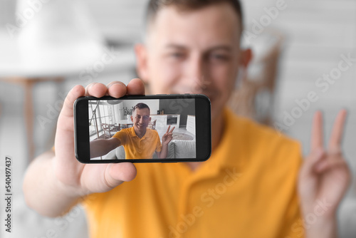 Young man showing victory g...