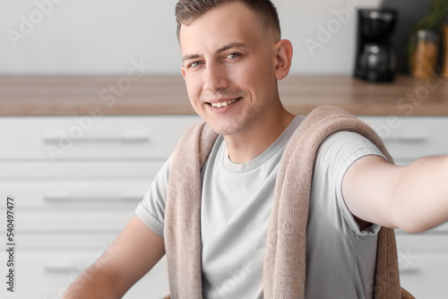 Young man taking selfie in ...