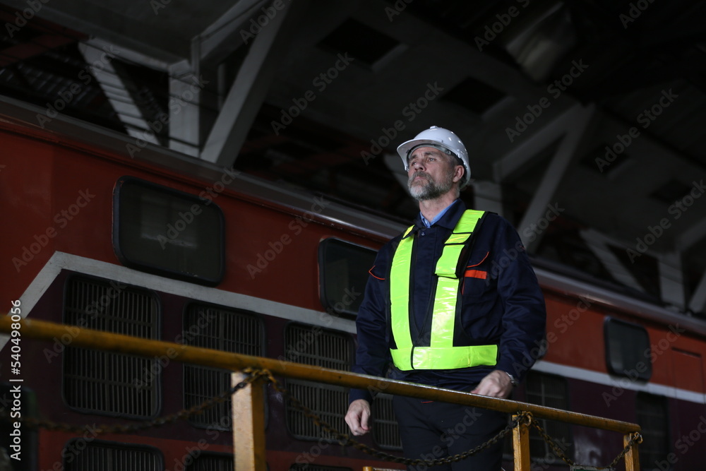 Man engineer standing on construction site of subway or maintenance equipment in factory Man engineer standing on construction site of subway or maintenance equipment in factory