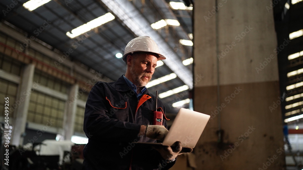 Factory engineer or foreman worker maintaining check equipment parts in factory. Factory engineer or foreman worker maintaining check equipment parts in factory.
