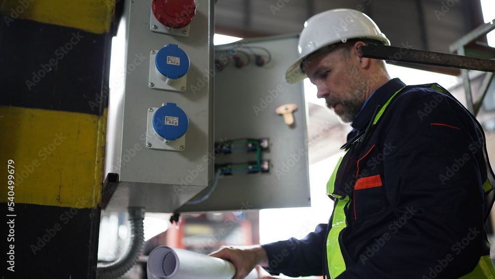 Engineers working at Factory in powerplant and maintenance check on electric control box in factory. Engineers working at Factory in powerplant and maintenance check on electric control box in factory.