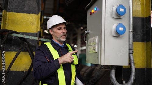 Engineers working at Factory in powerplant and maintenance check on electric control box in factory.