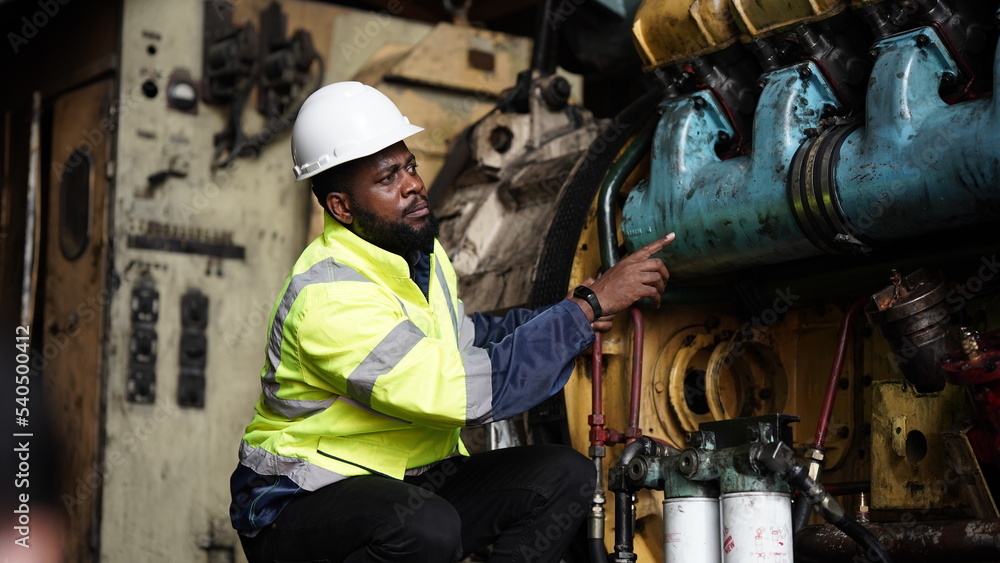 Portrait of maintenance engineer or apprentice in workshop of railway engineering facility Portrait of maintenance engineer or apprentice in workshop of railway engineering facility