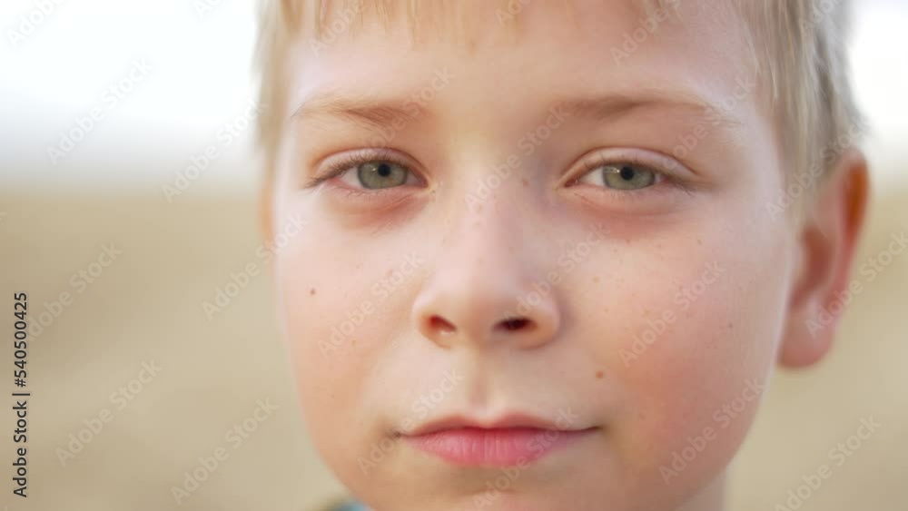 Portrait of white happy baby boy. Face of a beautiful healthy baby. Blond short hair. Attractive European face. Beautiful portrait of a child man in nature. Cheerful eyes hair in the wind.Joyful face. Portrait of white happy baby boy. Face of a beautiful healthy baby. Blond short hair. Attractive European face. Beautiful portrait of a child man in nature. Cheerful eyes hair in the wind.Joyful face.