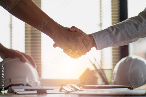 Engineer constructor handshake meeting with architect owner for agreement in contract building home project