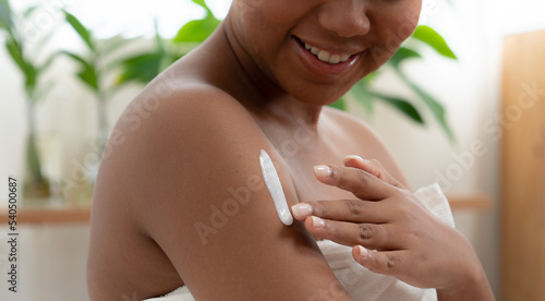 Картината върху платно African american black skin woman using lotion cream skin cleansing care on her