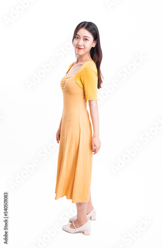 A beautiful, stylish woman in a yellow dress © 大 李
