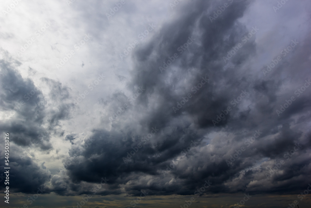 The dark sky with heavy clouds converging and a violent storm before the rain.Bad or moody weather sky and environment. carbon dioxide emissions, greenhouse effect, global warming, climate change The dark sky with heavy clouds converging and a violent storm before the rain.Bad or moody weather sky and environment. carbon dioxide emissions, greenhouse effect, global warming, climate change