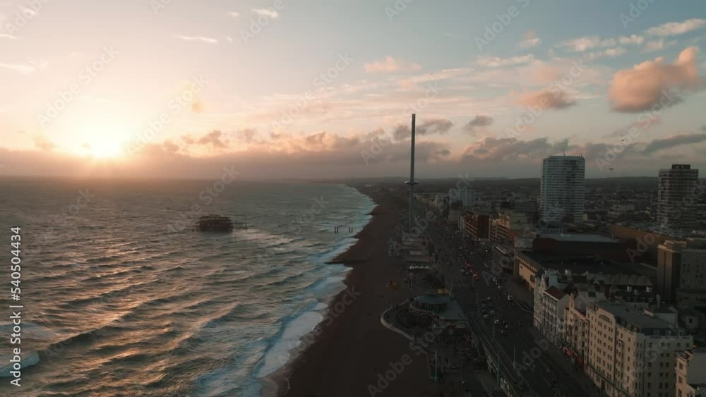 Magical sunset 4k aerial video of British Airways i360 viewing tower pod with tourists in Brighton, UK with sea and Brighton Palace Pier in the background. Magical sunset 4k aerial video of British Airways i360 viewing tower pod with tourists in Brighton, UK with sea and Brighton Palace Pier in the background.