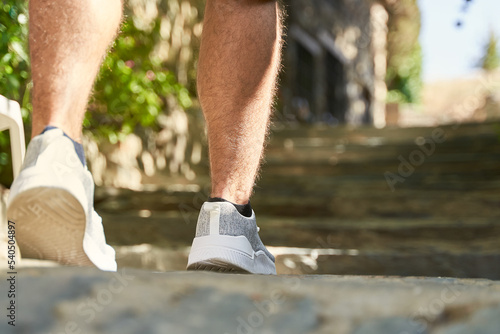 Detail of sneakers of hiker by slate stones steps in Patones de Arriba photo
