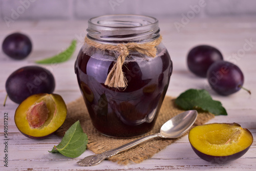 Plum jam with jam in a jar. Close-up.
