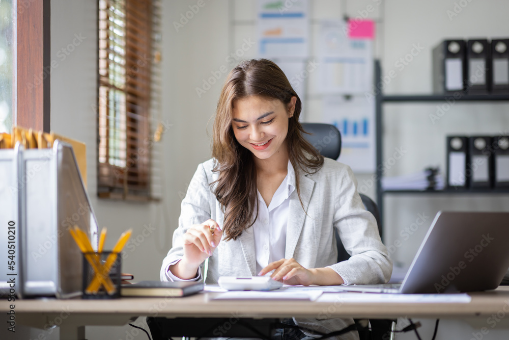 Young business multiethnic Asian women Accounting using calculating laptop income-expenditure and analyzing real estate investment data report Financial and tax systems in workplace office. Young business multiethnic Asian women Accounting using calculating laptop income-expenditure and analyzing real estate investment data report Financial and tax systems in workplace office.