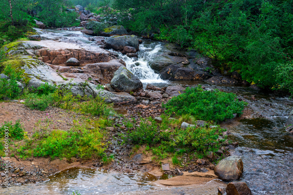 rapids of mountain rivers with fast water and large rocky boulders