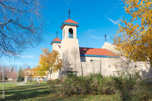 Side view of Cathedral building with beautiful Betula neoalaskana or Alaska birch, also known as paper birch or resin birch yellow fall foliage in Anchorage