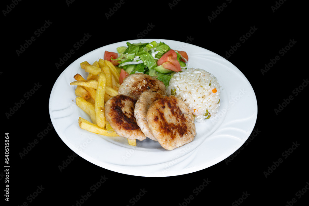 Grilled chicken meatballs with rice, salad and french fries in a white plate Grilled chicken meatballs with rice, salad and french fries in a white plate