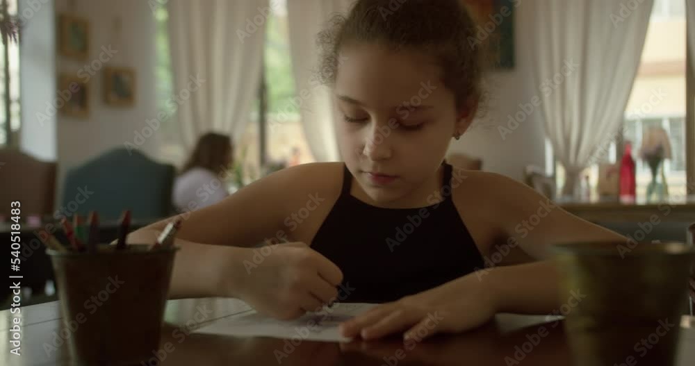 Child draws against the background of scolding parents, child sitting at home and drawing on paper with colored pencils. Child draws against the background of scolding parents, child sitting at home and drawing on paper with colored pencils.