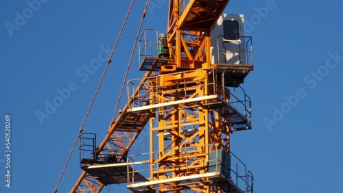 Wallpaper Mural Yellow tower crane on a construction site (detail), against clear blue sky, illuminated by late afternoon sun. Torontodigital.ca