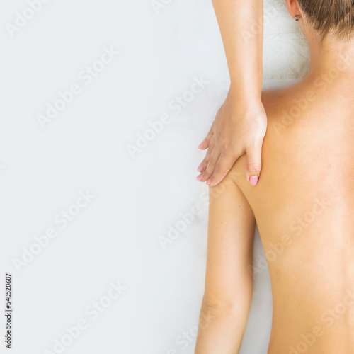 massage of the back and collar zone, hands of the massage therapist massage the neck and back, top view