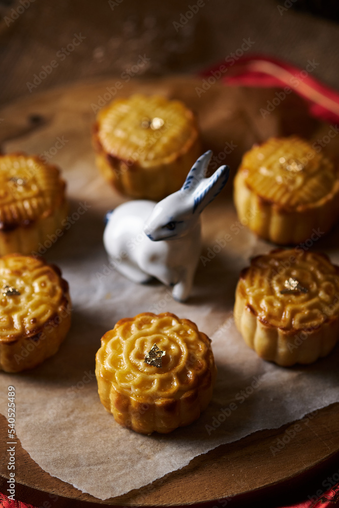 Mooncake a Chinese traditional pastry for Mid-Autumn festival. set on rustic wooden table.