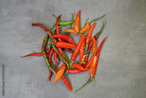 bunch of fresh chilies on a concrete background